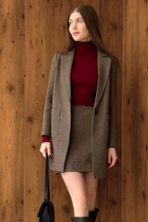 a lady in a red sweater, a grey skirt and a grey unisex coat